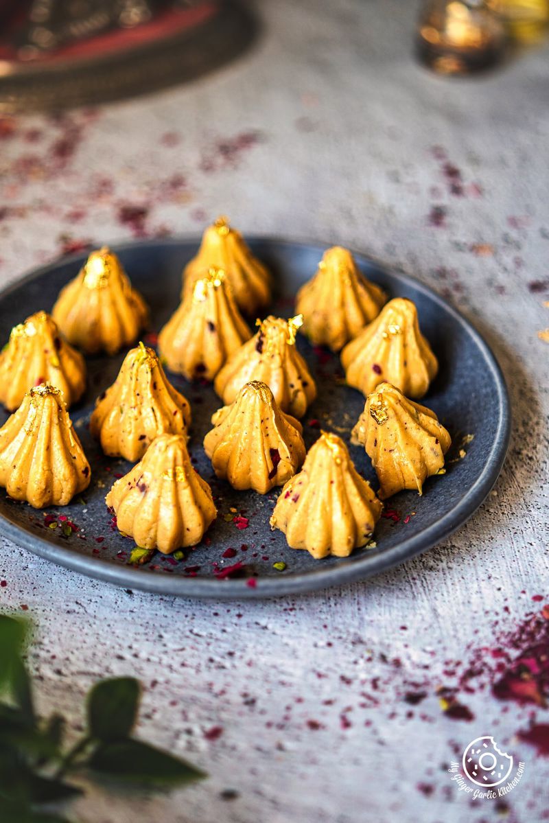 photo of a plate of yellow Dulce De Leche Modak on a table