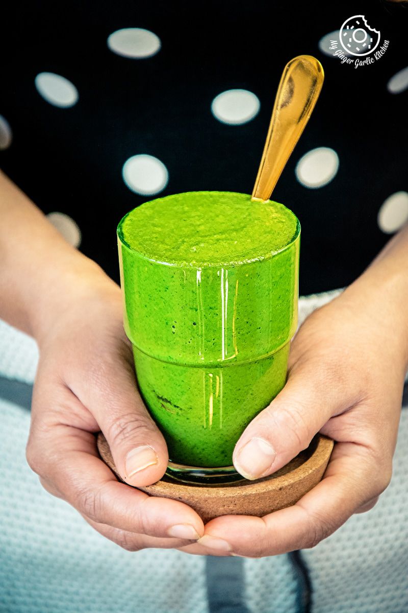 a female holding mint coriander chutney jar