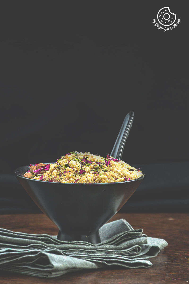 a bowl of churma with a spoon in it