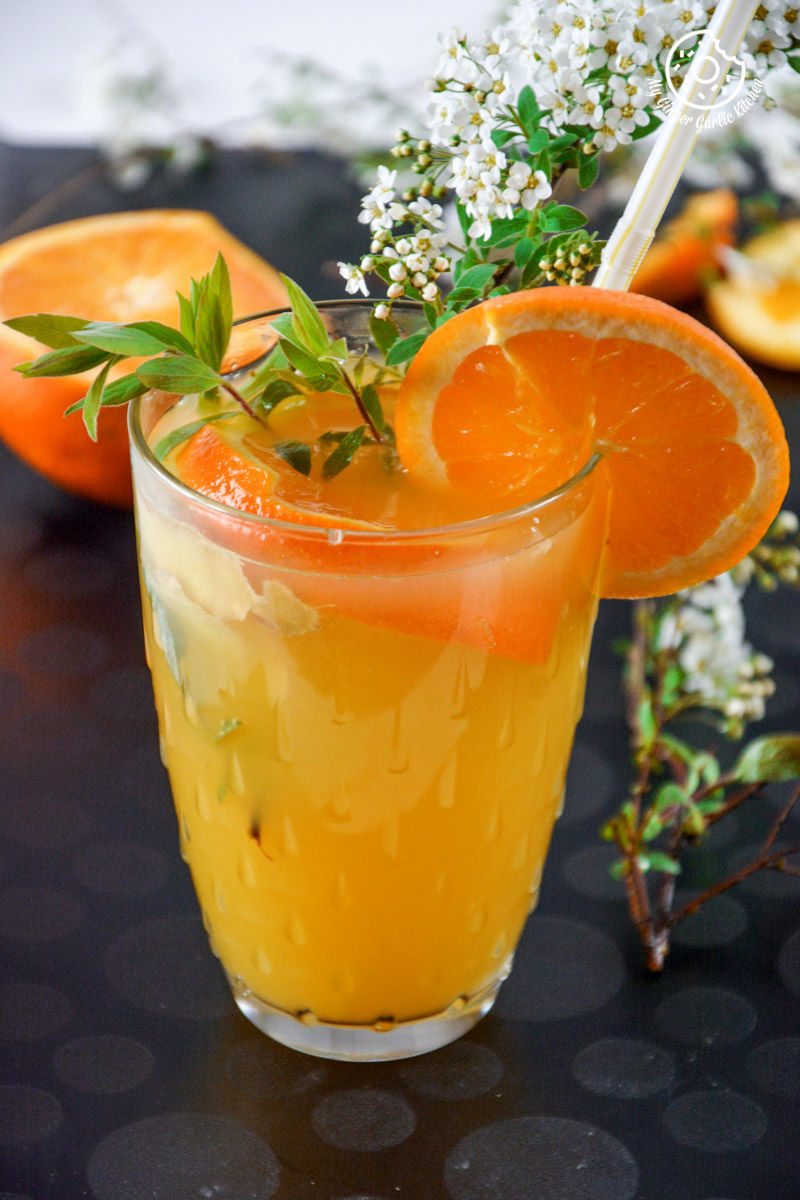 a glass of virgin ginger mimosa with a straw