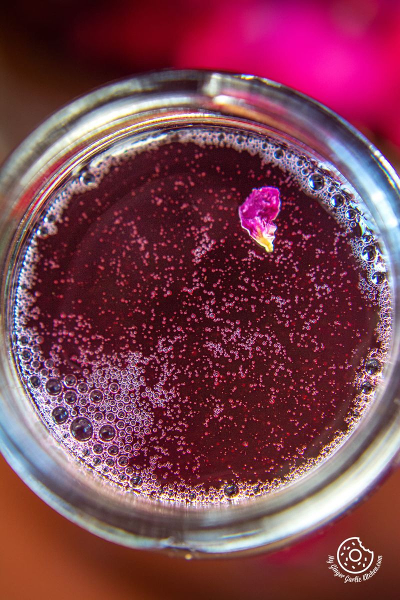 overhead close up shot of rose syrup in a glass bottle