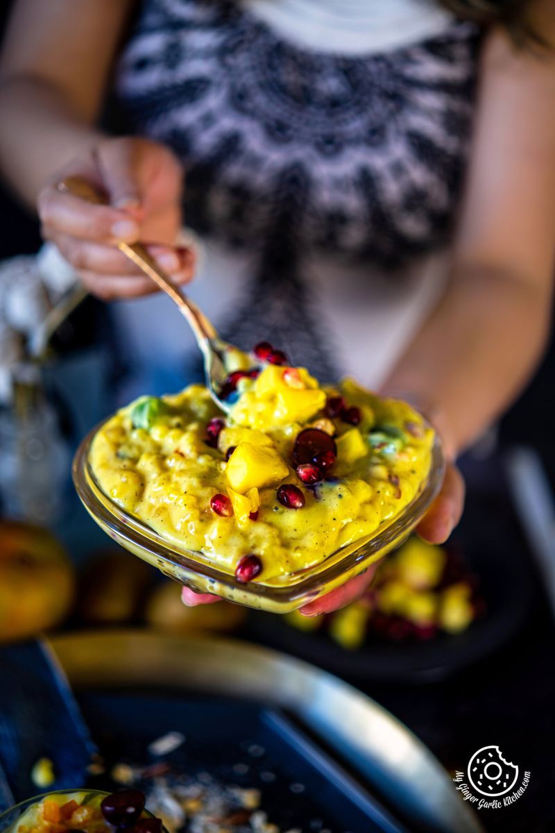 a female holding a transparent bowl filled with sago fruit custard